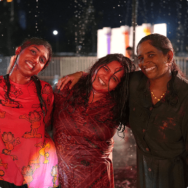 Employees participating in an evening social event that promotes connection and belonging.